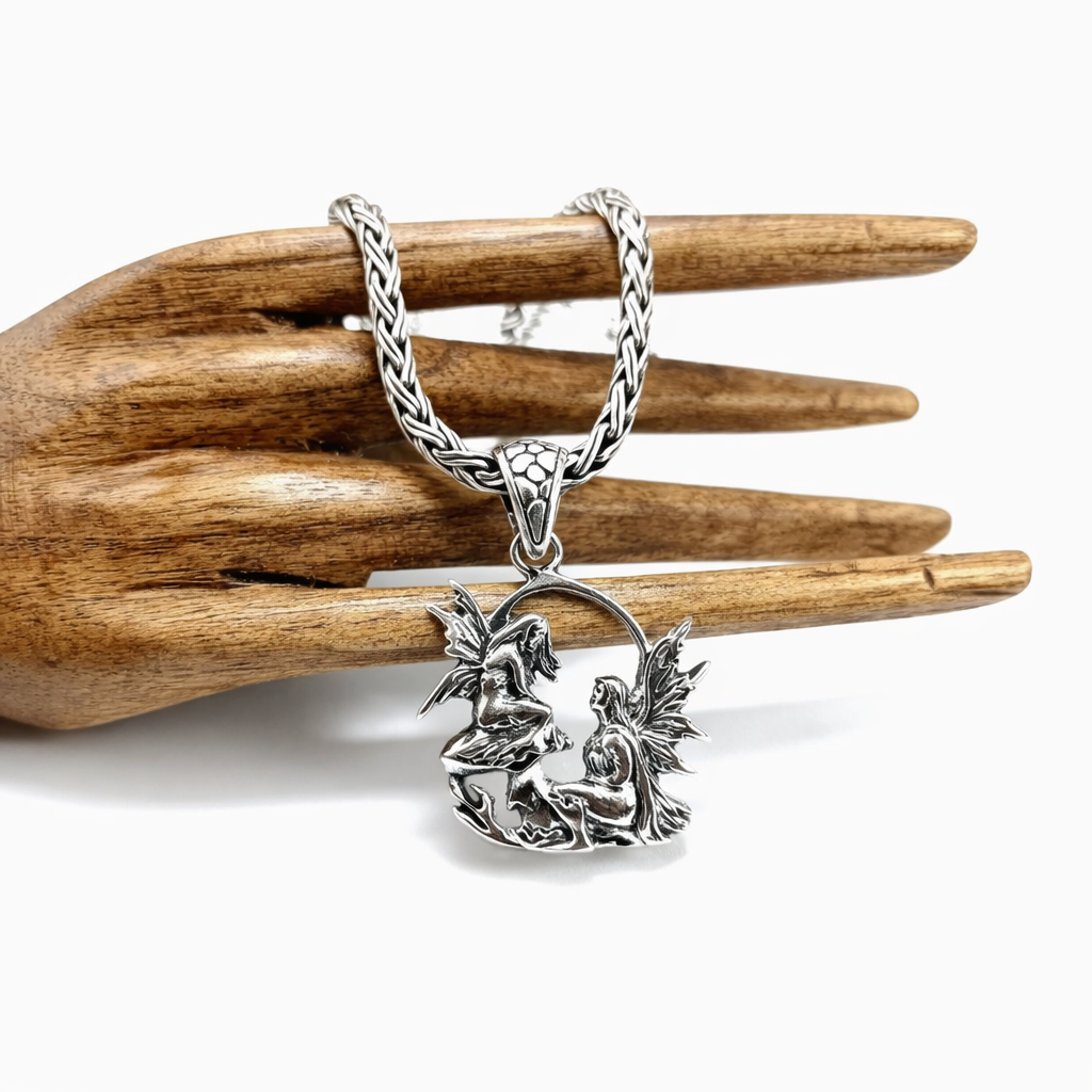 Artisan silver pendant featuring angel figures, handcrafted from 925 sterling silver